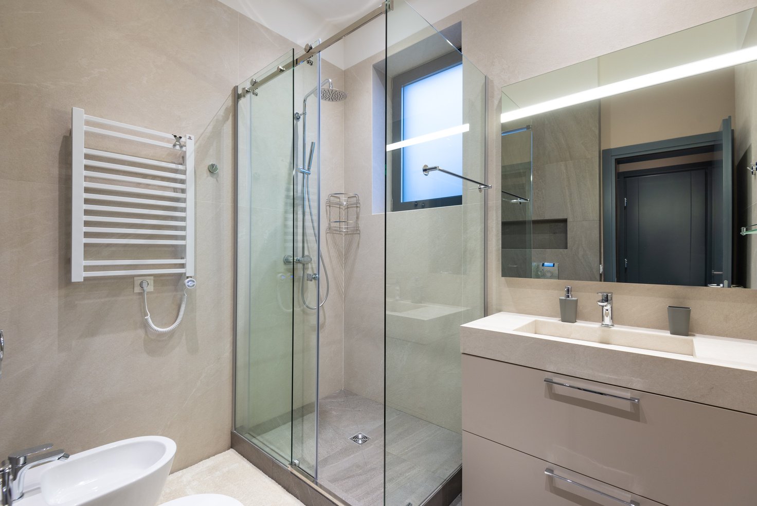 Interior of modern bathroom with glass shower cabin